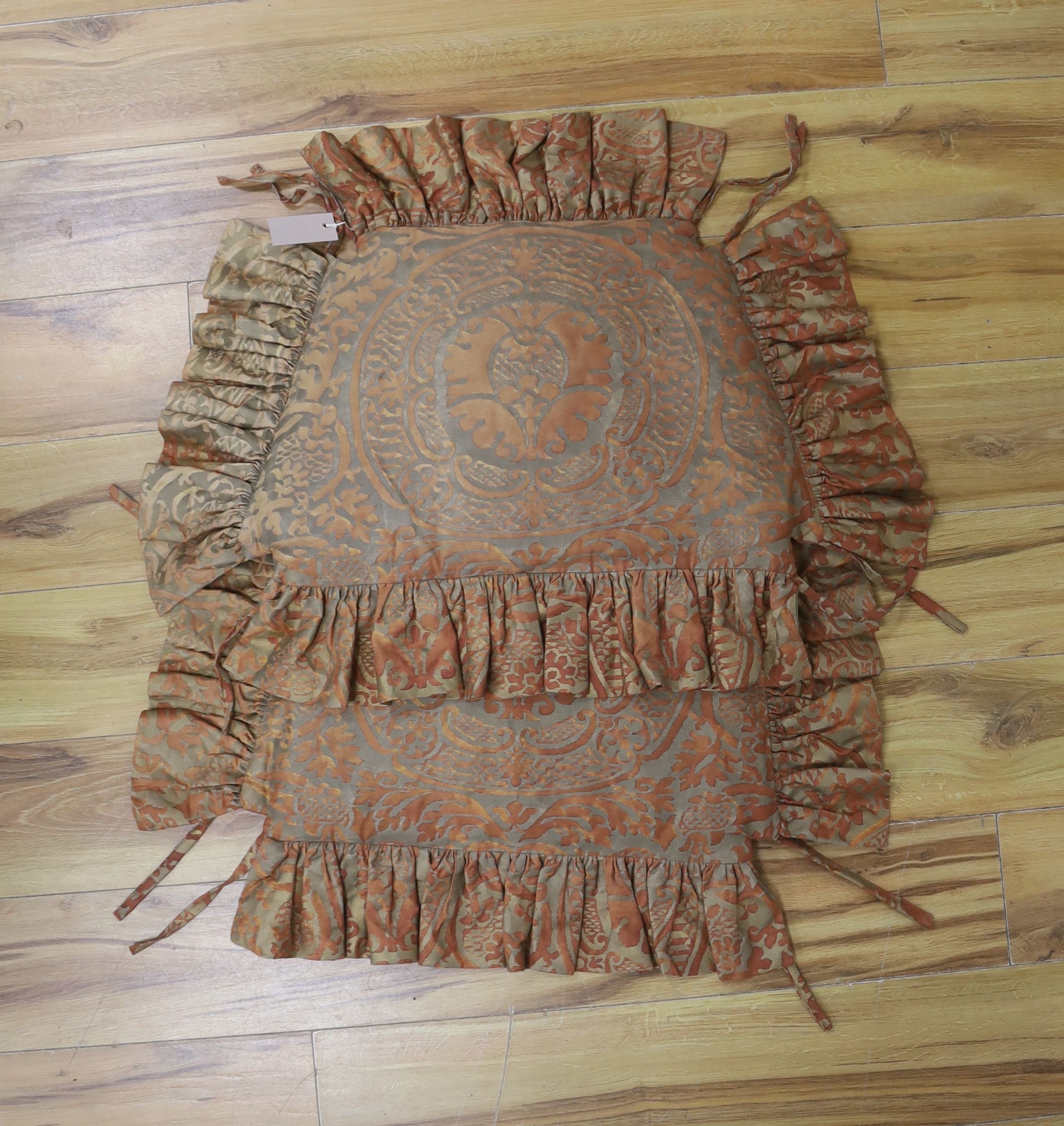 A pair of Fortuni 'Orsini pattern' seat cushions in rust and gold colourway